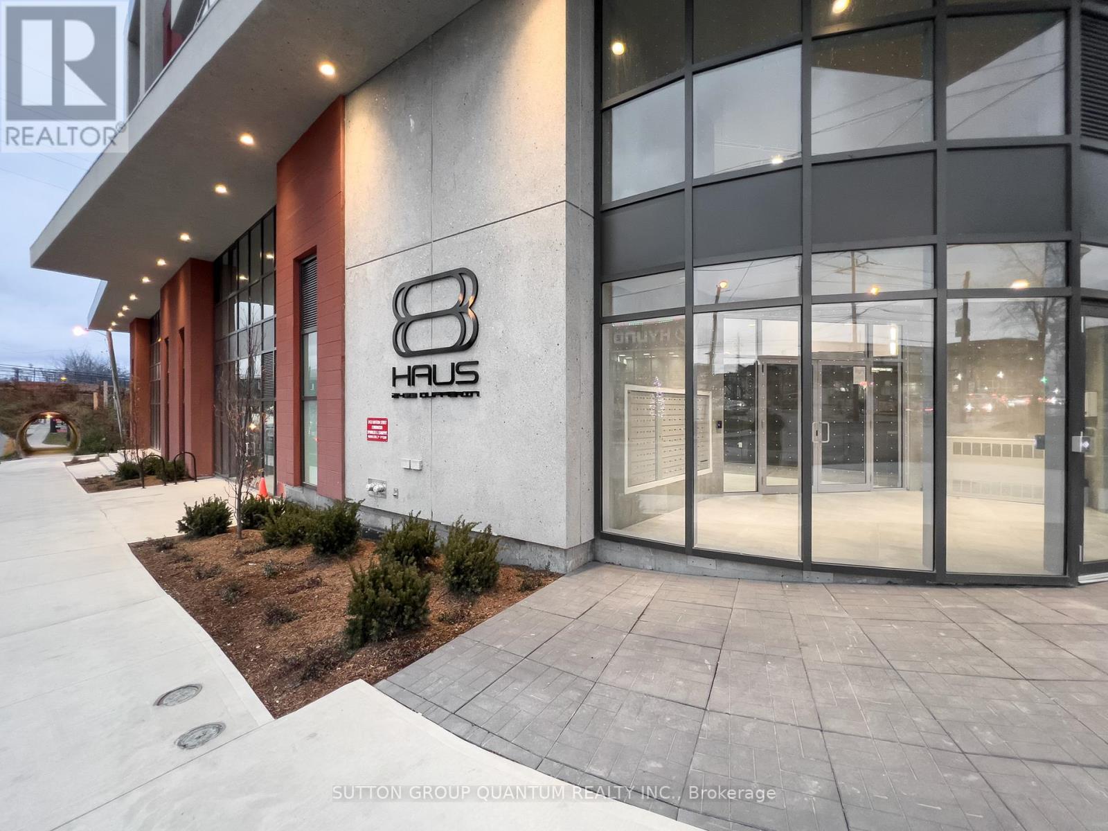 A modern building with the number 8 Haus on the side.