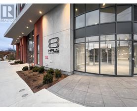 A modern building with the number 8 Haus on the side.