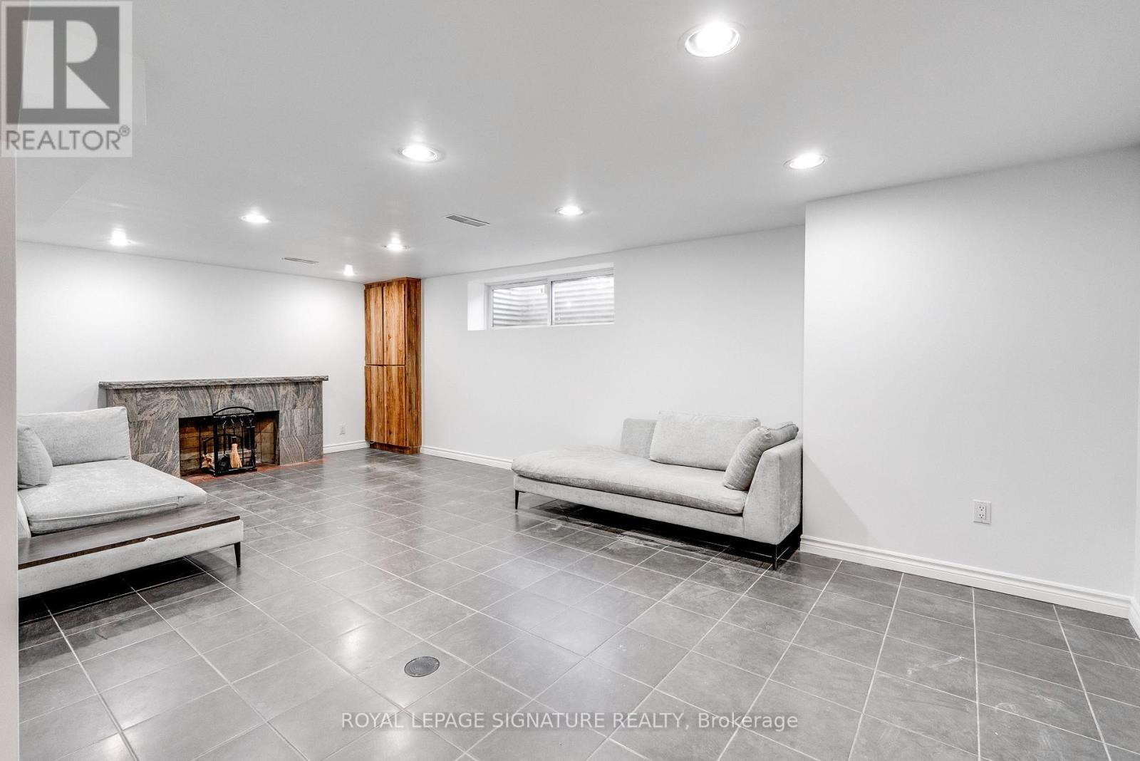 A living room with a fireplace and two couches.