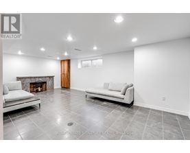 A living room with a fireplace and two couches.