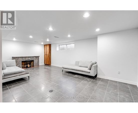 A living room with a fireplace and two couches.