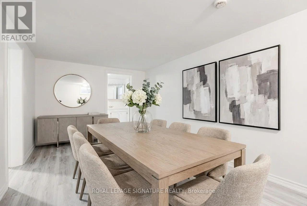 A dining room with a wooden table and chairs.