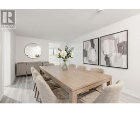 A dining room with a wooden table and chairs.