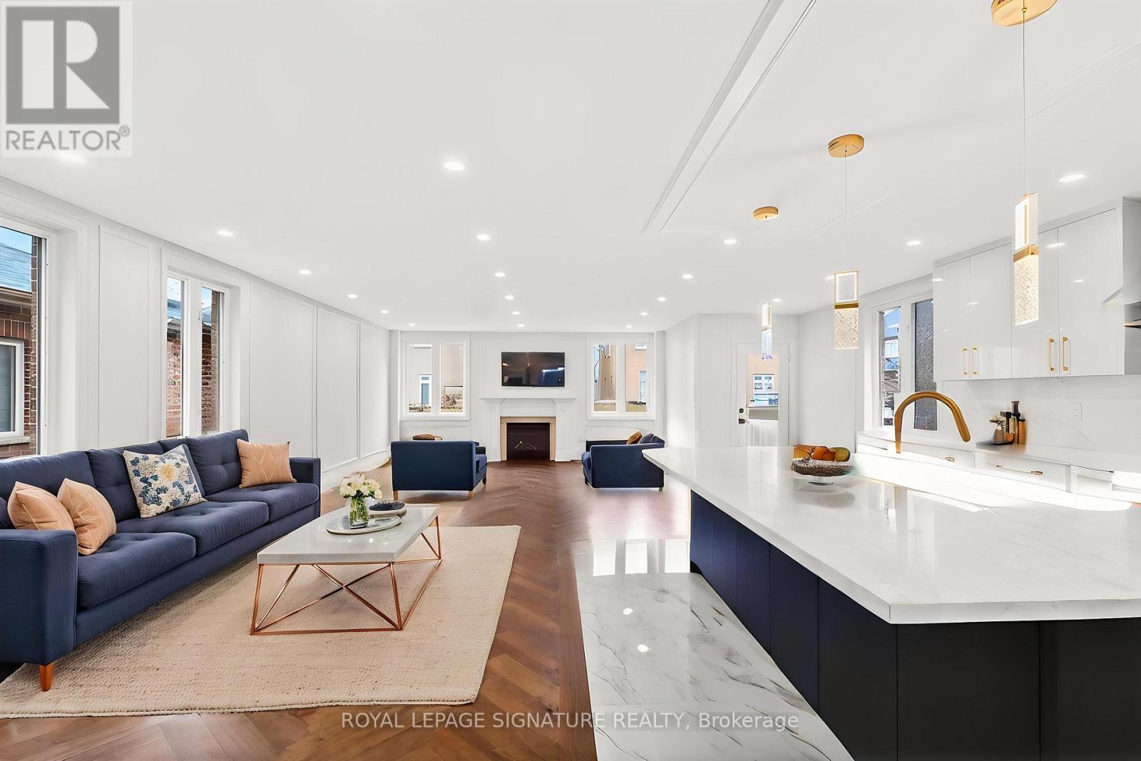 A modern living room with a dark blue sofa and a coffee table.