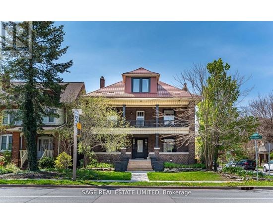A house with a red roof and a sign that says SAGE REAL ESTATE LIMITED, Brokerage.