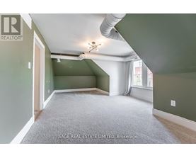 A room with a carpet floor and a ceiling fan.