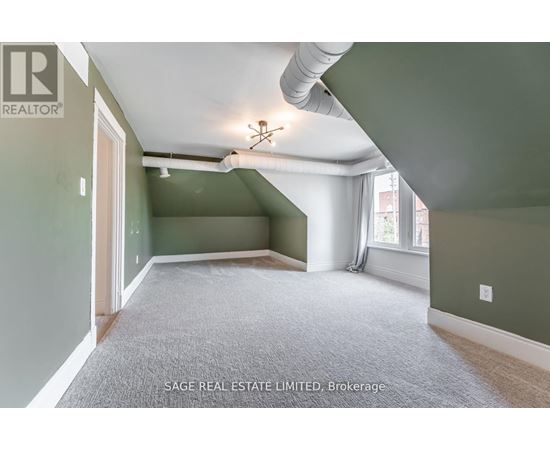 A room with a carpet floor and a ceiling fan.