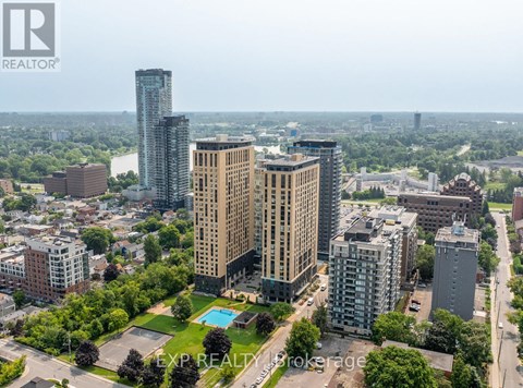 A cityscape with a tall building in the center and a pool in the foreground.