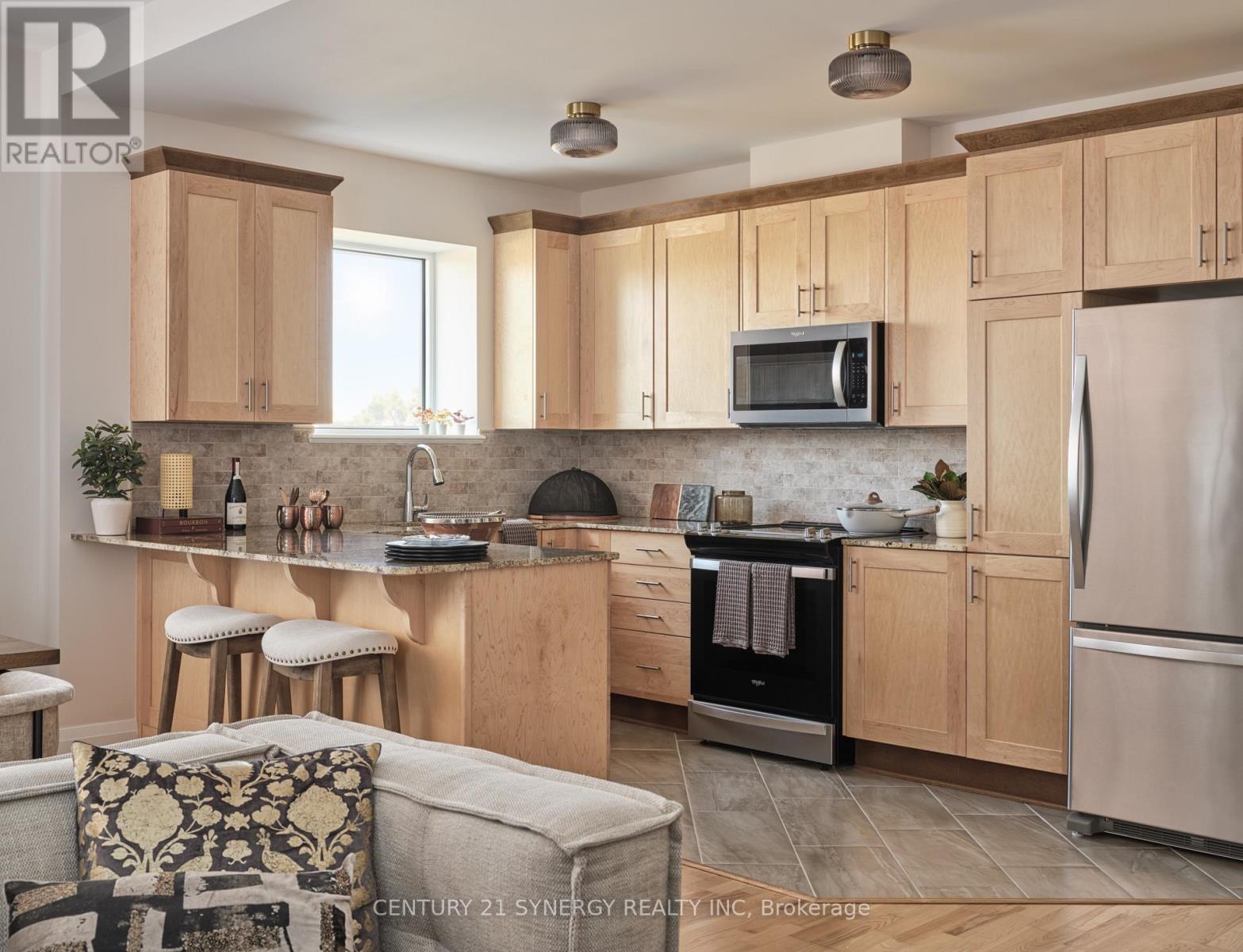 A kitchen with wooden cabinets and a stainless steel refrigerator.