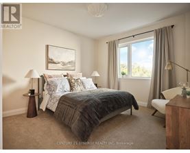 A bedroom with a large bed and a painting on the wall.
