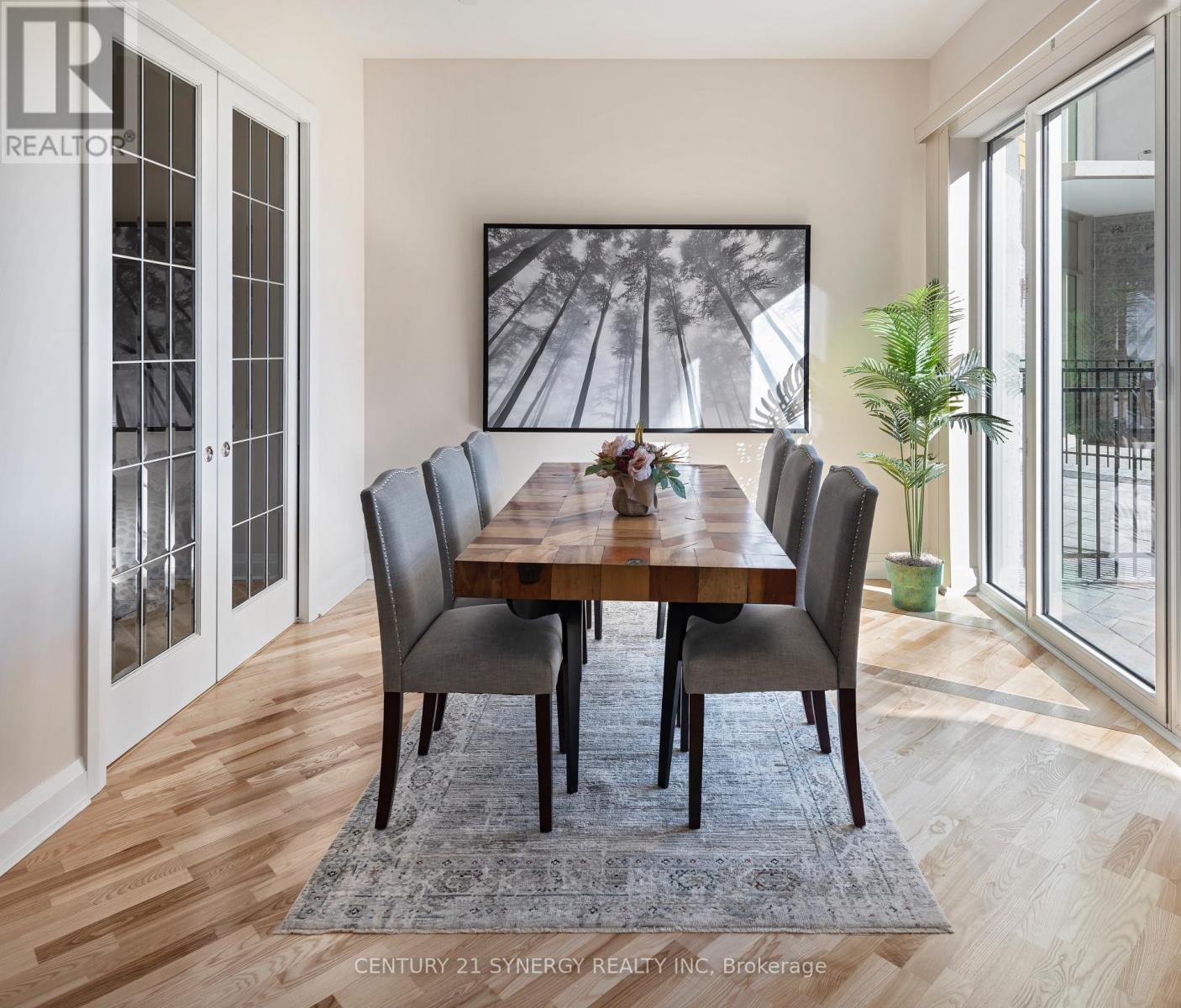 A dining room with a wooden table and chairs.