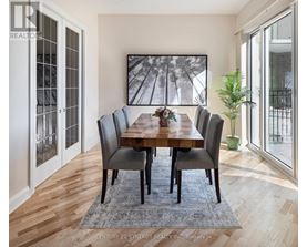 A dining room with a wooden table and chairs.