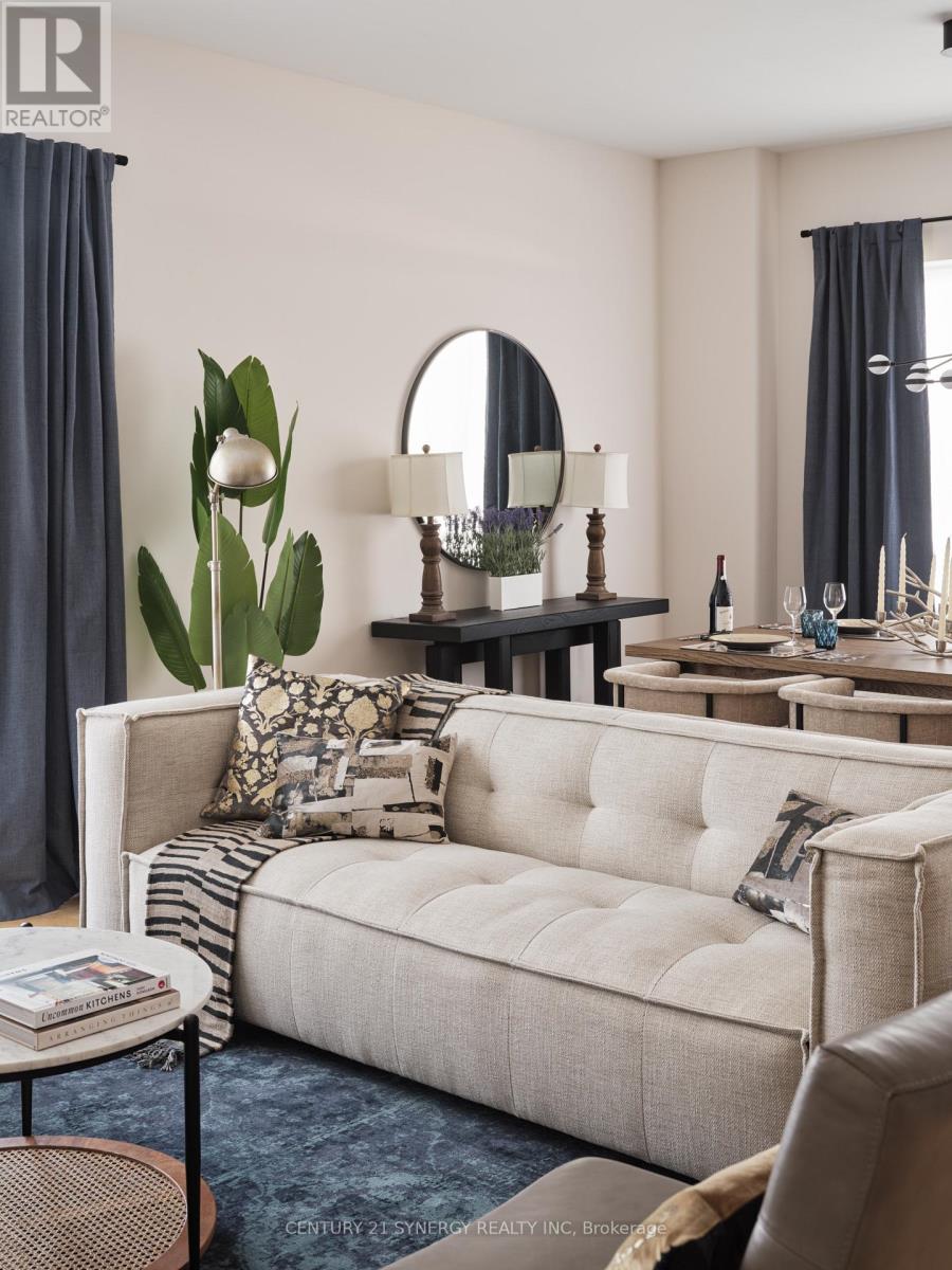 A living room with a white sofa and a round mirror on the wall.