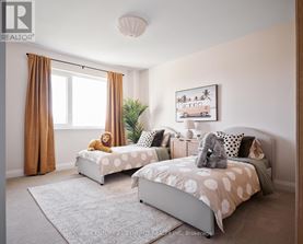 A bedroom with two beds and a painting on the wall.