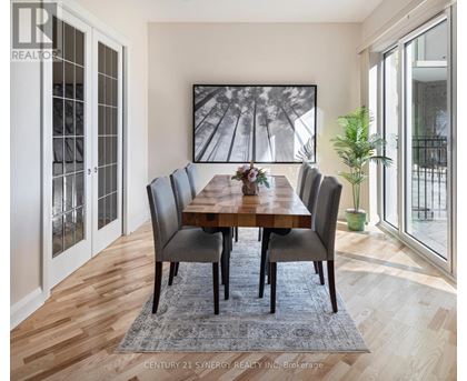 A dining room with a wooden table and chairs.