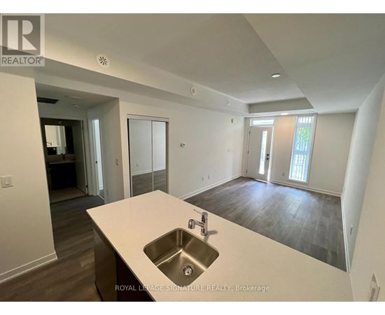 A spacious kitchen with a sink and a countertop.