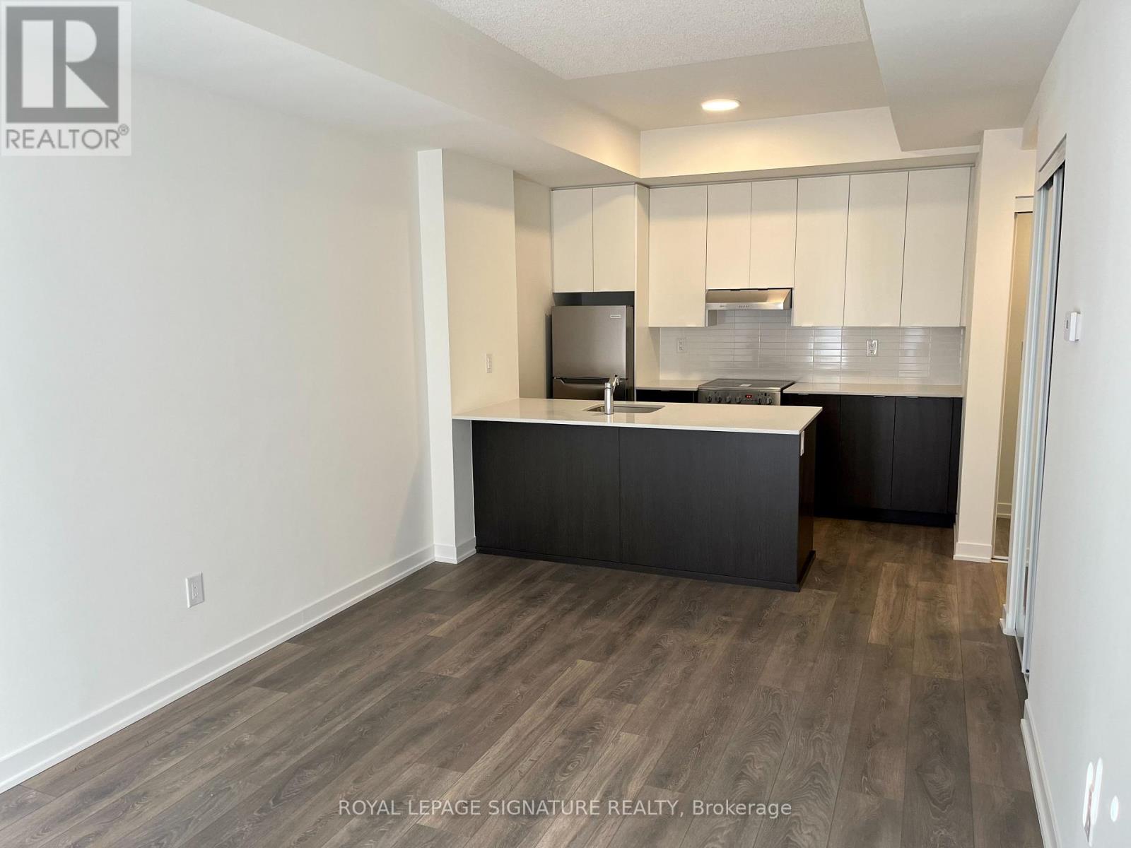 A kitchen with a black counter top and white cabinets.