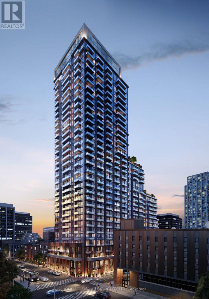 A tall building with a glass facade stands in the foreground of a cityscape at dusk.