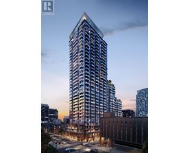 A tall building with a glass facade stands in the foreground of a cityscape at dusk.