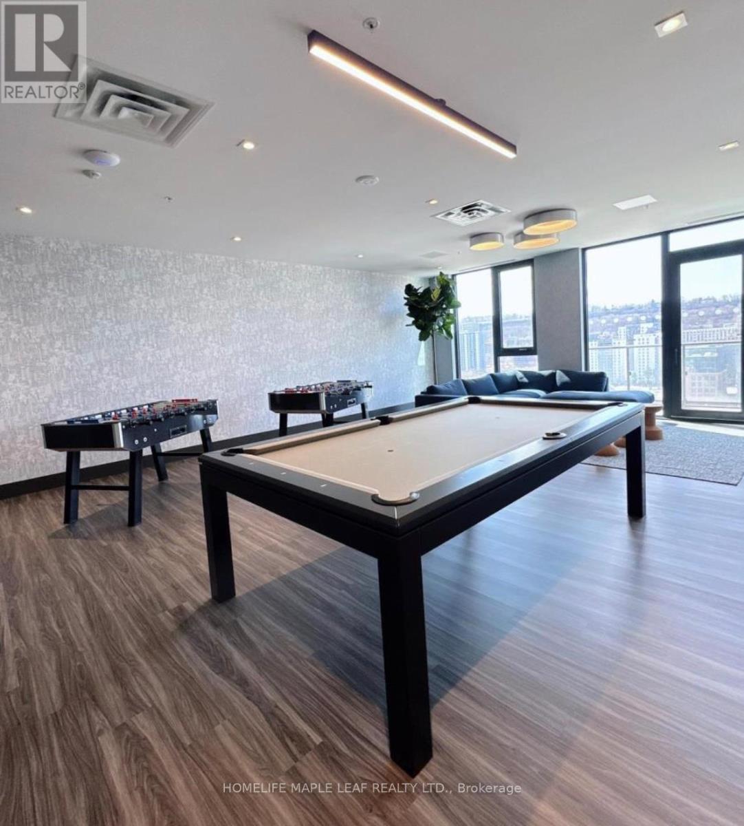 A pool table in a room with a view of the city.
