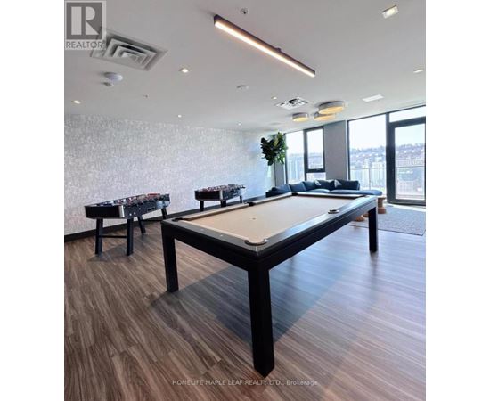 A pool table in a room with a view of the city.