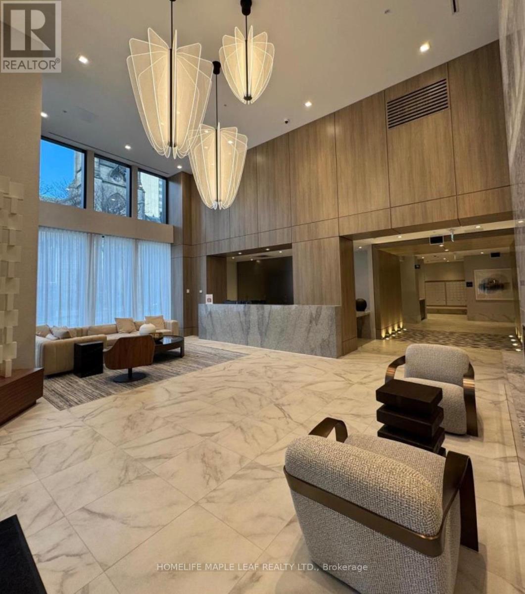 A spacious living room with a marble floor and elegant furniture.