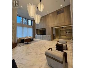 A spacious living room with a marble floor and elegant furniture.