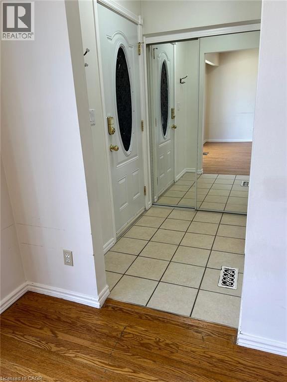 A white door with a round window is in a hallway.