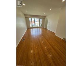 A room with wooden flooring and a sliding glass door.