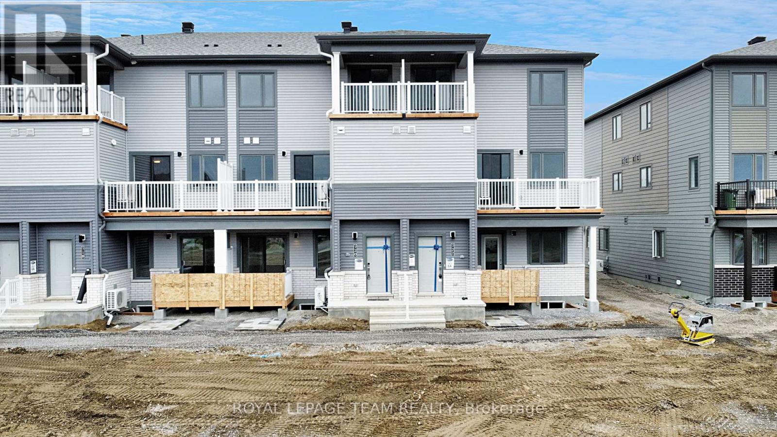 A row of new townhouses are under construction.