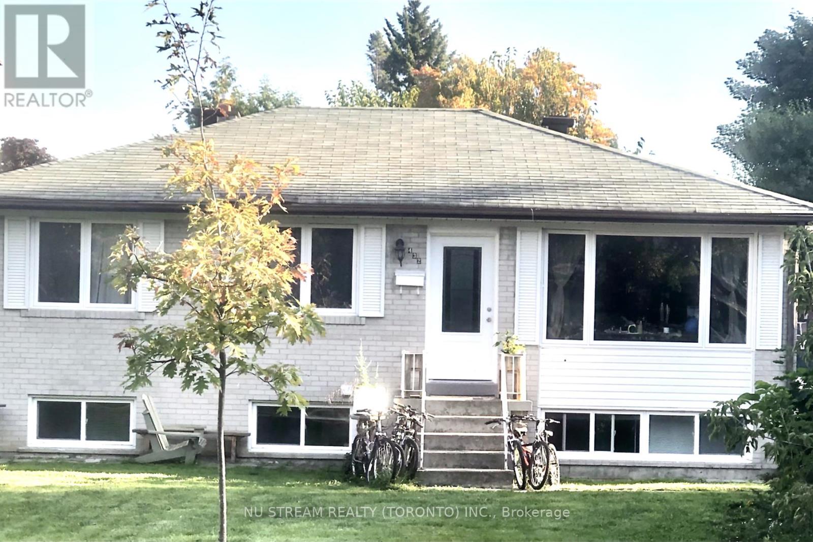 A house with a tree in front of it.