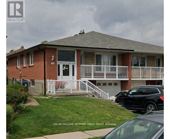 A house with a white fence and a black car parked in front.