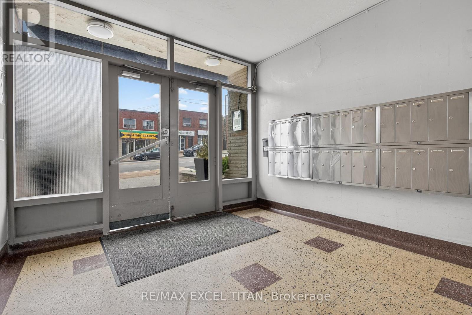 A brokerage office with a glass door and a wall of mailboxes.