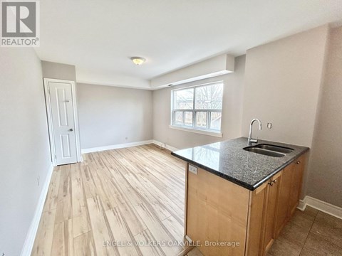 A kitchen with a sink and a window.