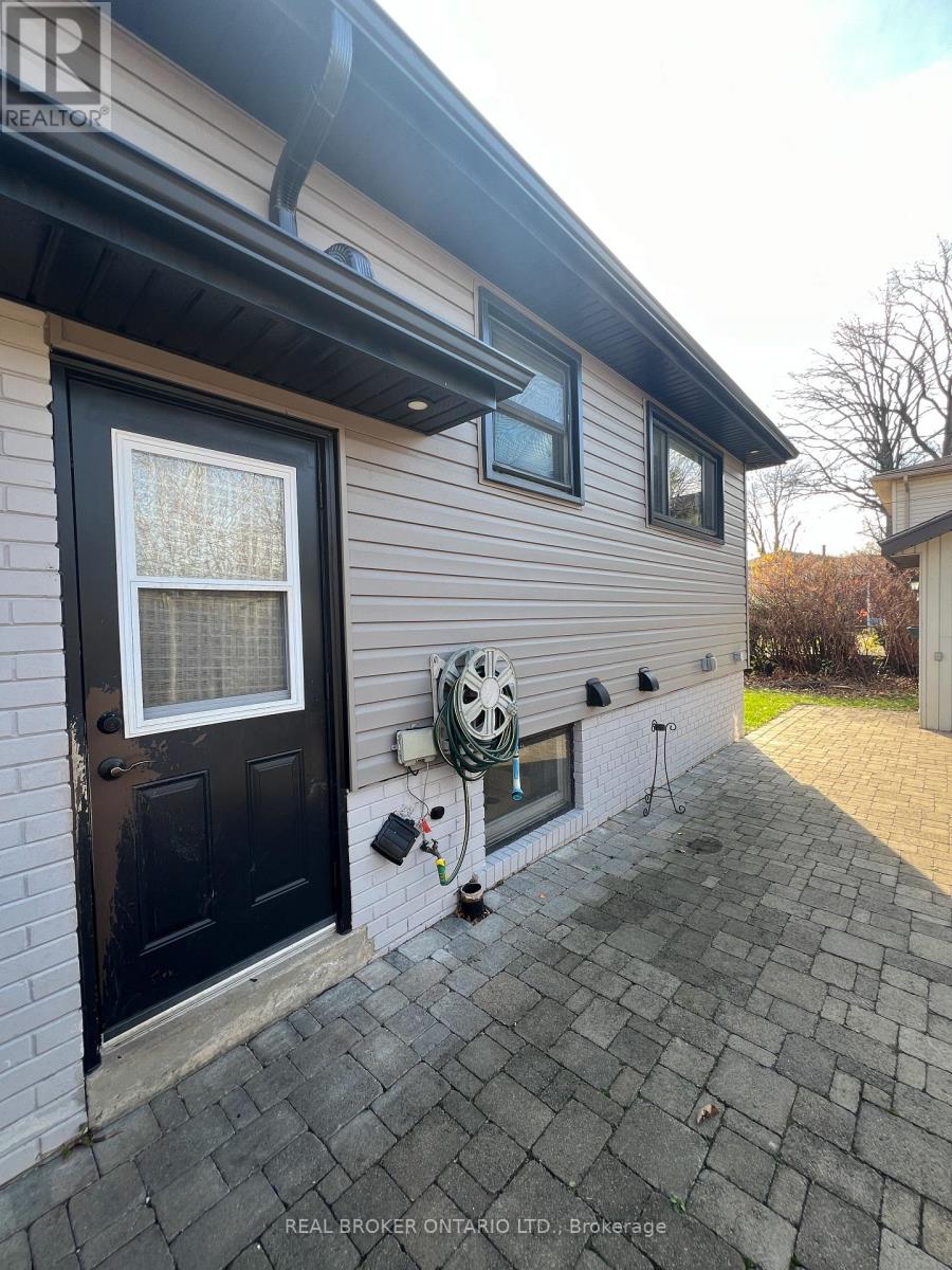 A house with a black door and a window with a white curtain.