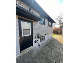 A house with a black door and a window with a white curtain.