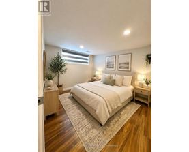 A bedroom with a large bed, a nightstand, and a small tree.