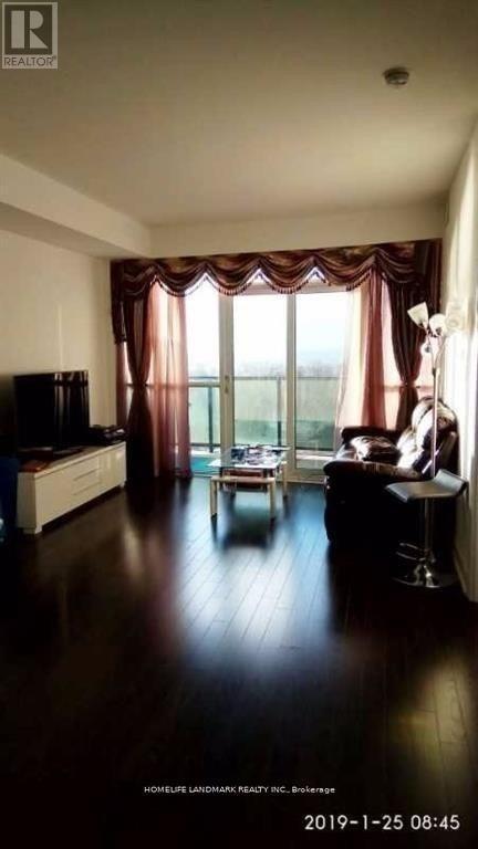 A living room with a television, a sofa, and a table.
