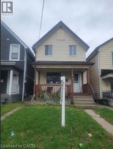 A house with a sign that says "Licensed to CAOR" in front of it.