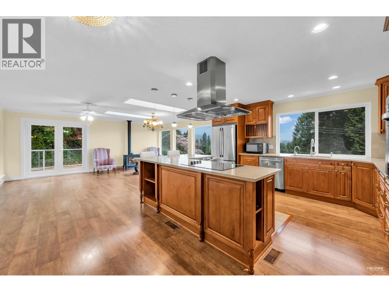 A spacious kitchen with wooden cabinets and a central island.