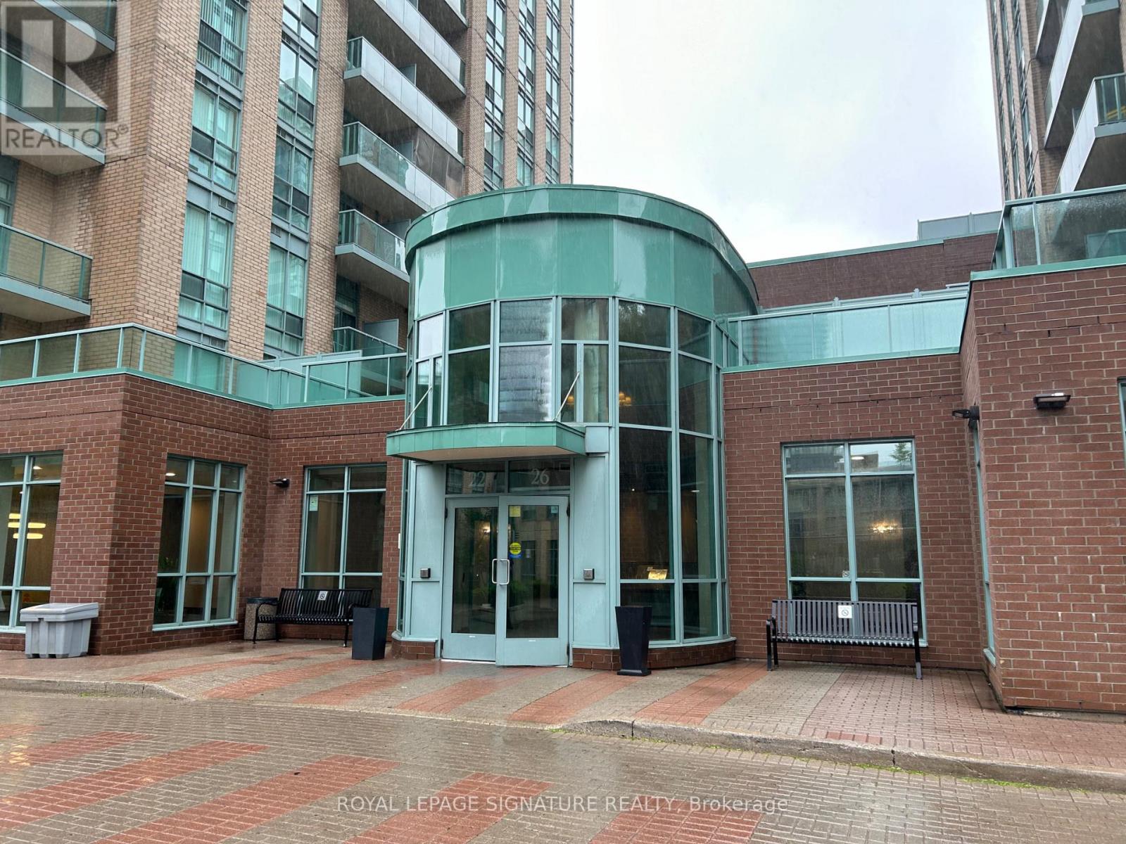 A building entrance with a glass door and a sign that says "Royal LePage Signature Realty Brokerage".