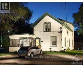 A house with a car parked in front of it.