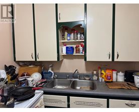 A kitchen with a sink and cabinets.