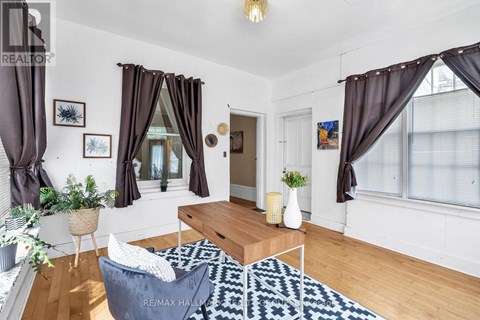 A living room with a white sofa and a coffee table.