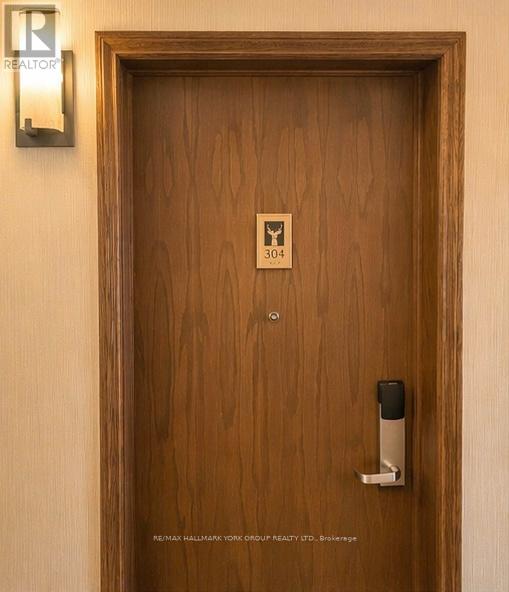 A brown door with a keypad and a sign on it.