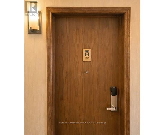 A brown door with a keypad and a sign on it.