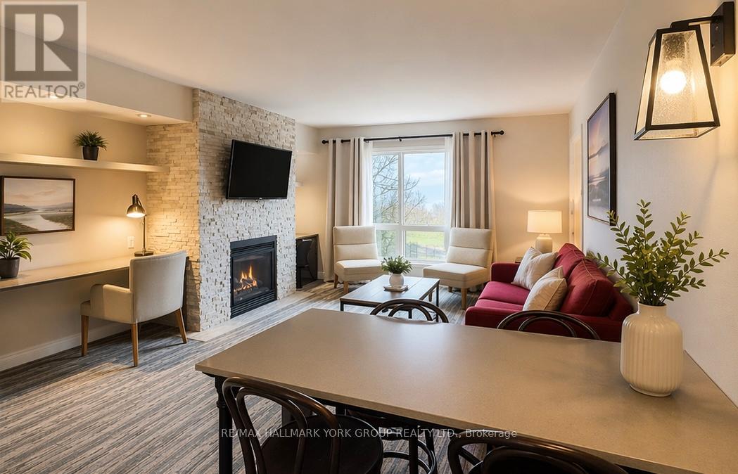 A living room with a fireplace and a television on the wall.