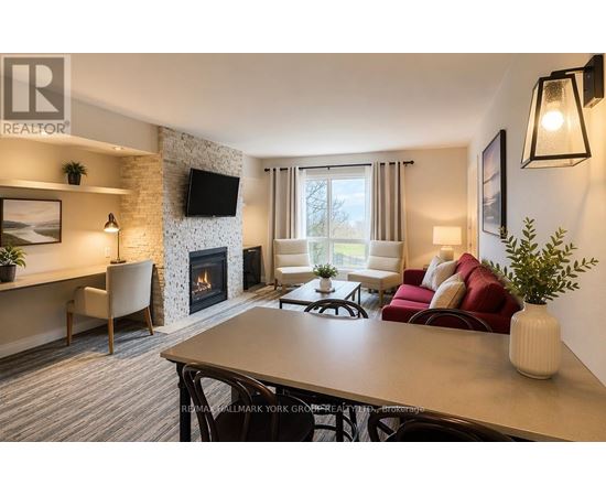 A living room with a fireplace and a television on the wall.