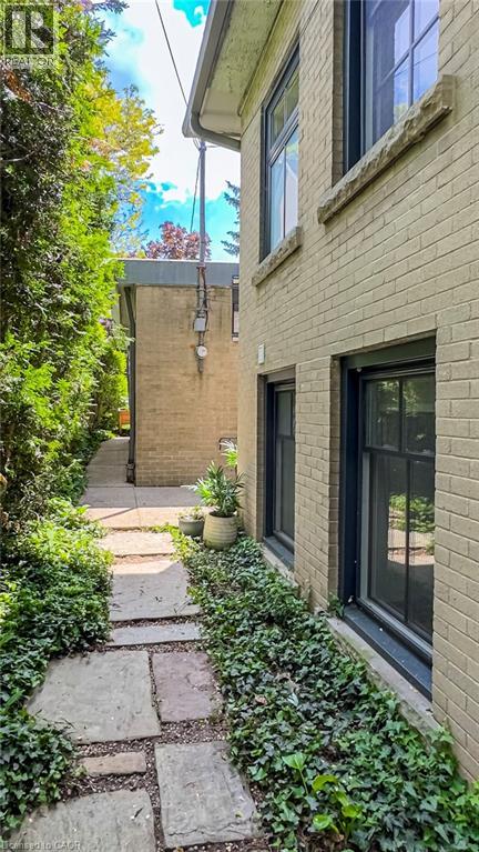 A brick building with a stone pathway leading to the front door.