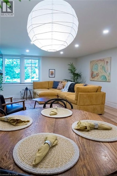 A living room with a yellow sofa and a wooden table.